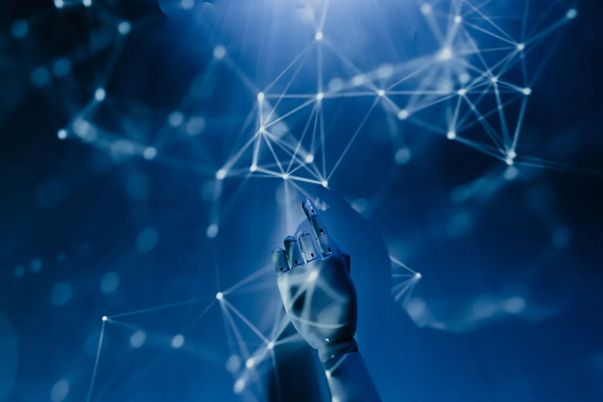 A glowing network of connected points forming a reaching hand