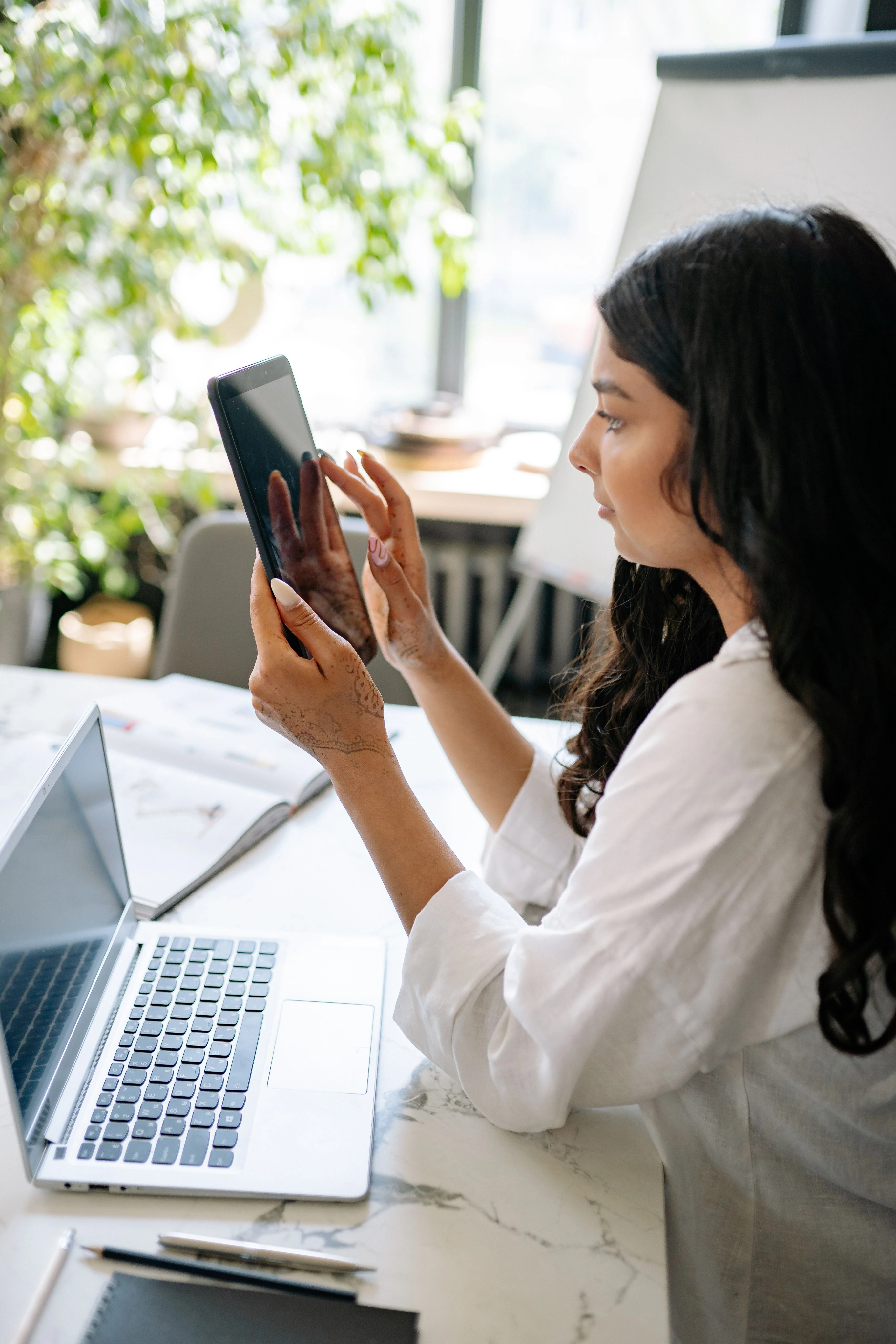 Startup founder working with laptop and tablet